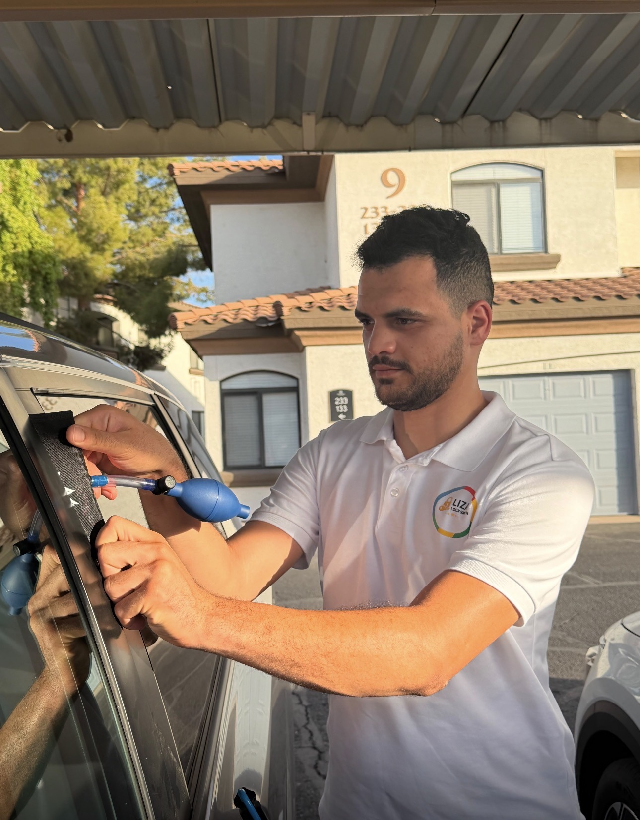 Liza Locksmith technician opening a locked car door on a Phoenix car lockout call