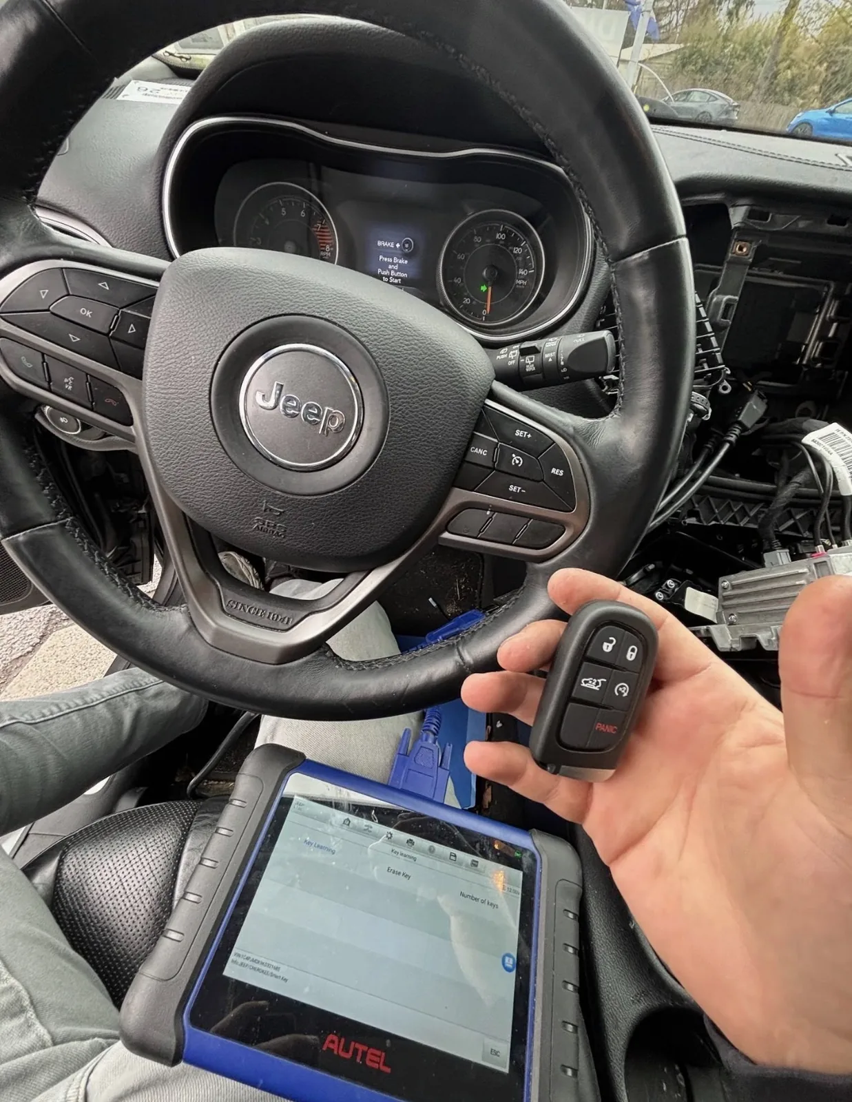 Jeep key fob programming underway with a diagnostic tablet connected inside the vehicle