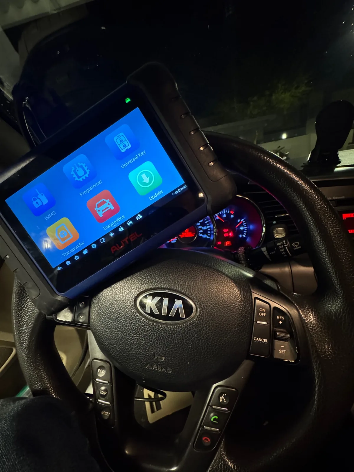 Autel key programmer connected to a Kia during a mobile programming job