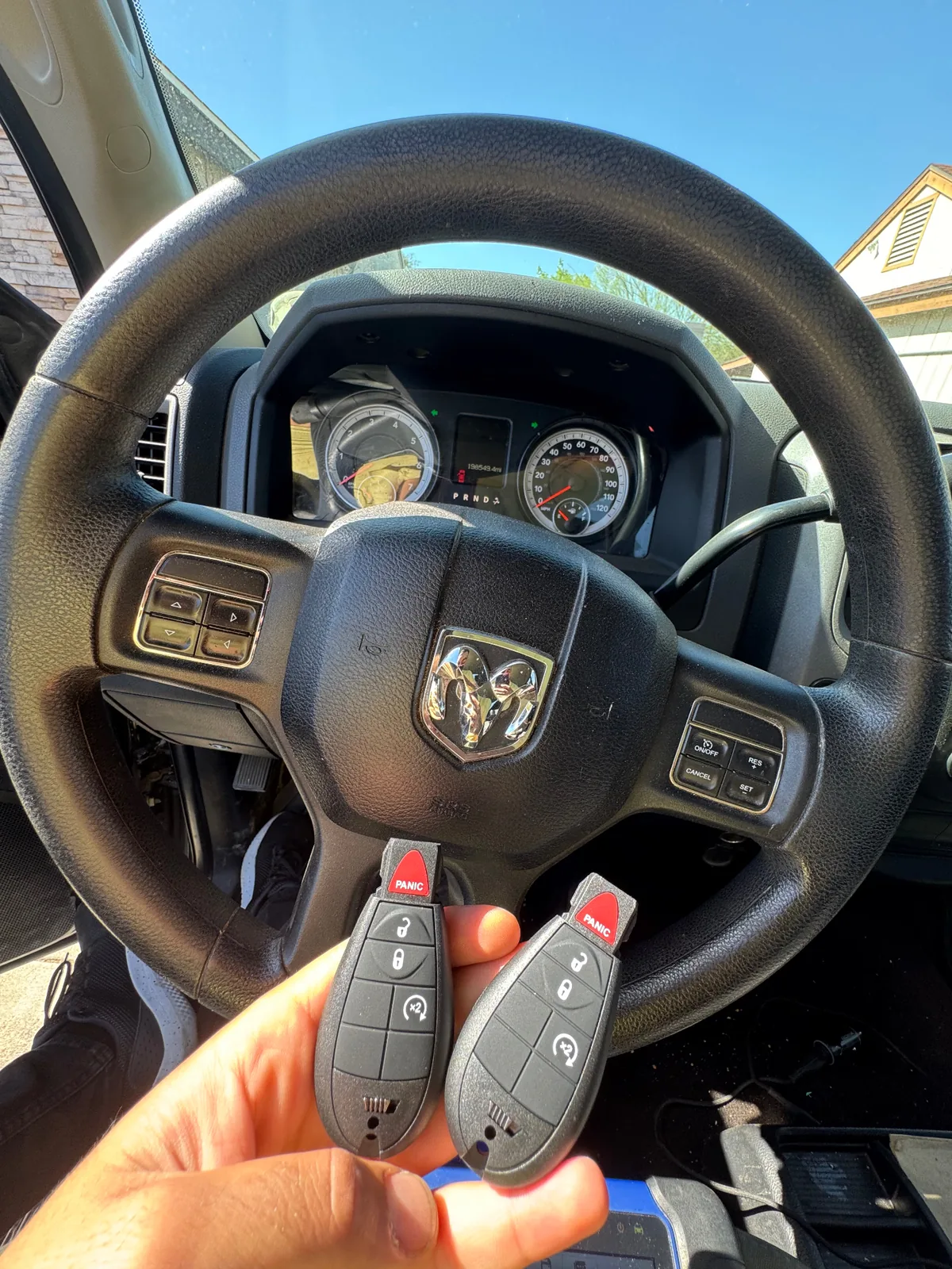 Duplicate RAM truck keys held inside a RAM vehicle after mobile key service