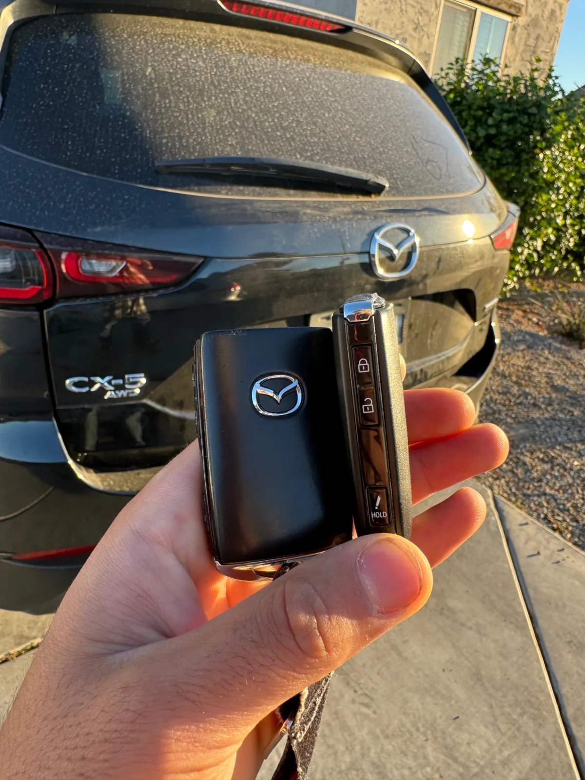 New Mazda CX-5 smart key held in front of a Mazda CX-5 after a real mobile locksmith replacement job